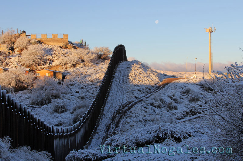 Snow on the the Mexico border wall that bisects Ambos Nogales
